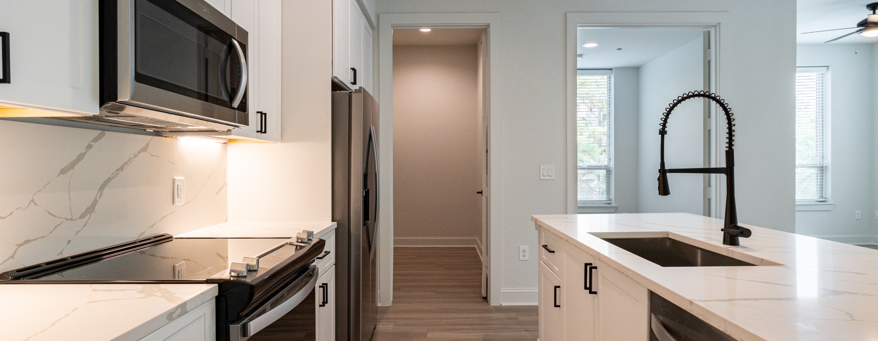 Spacious and well lit kitchen with wood like flooring