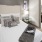 Spacious and well lit bedroom with plush carpet and large windows