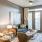 Spacious and well lit living room with wood floors and an open floor plan with access to the kitchen.