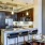 Spacious and well lit kitchen with wood floors and stainless steel appliances. 