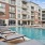 umbrella shaded lounge chairs surround pool